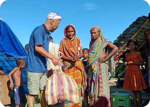 People in colorful traditional clothing at an outdoor market.