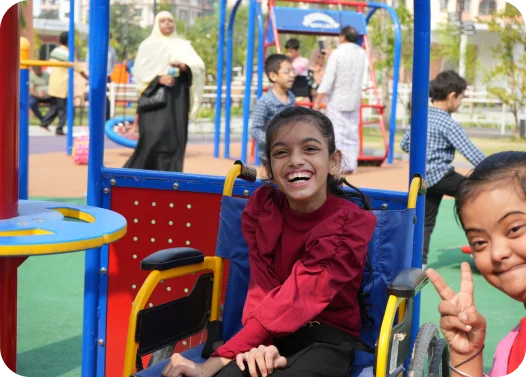 Child in red sitting on a blue playground train.