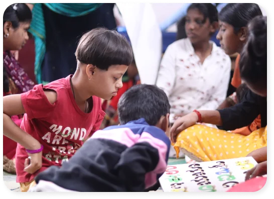 Children engaged in an arts and crafts activity on the floor.