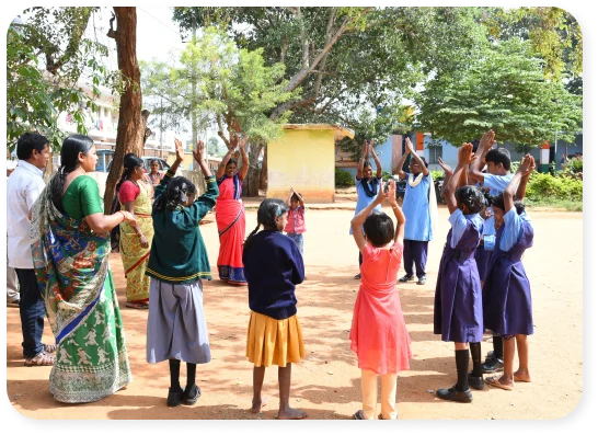 Group of children playing a game with adults outdoors under a sunny sky.