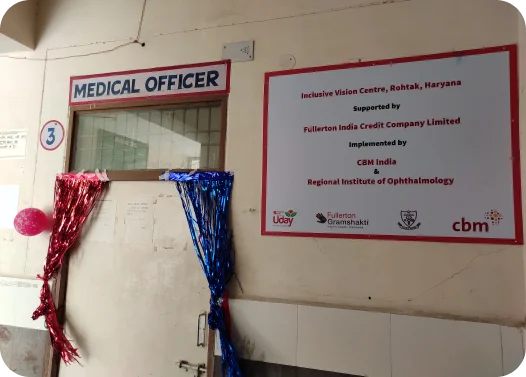 Entrance to a Medical Officer's office with festive tinsel and an 'Inclusive Vision Centre' sign.