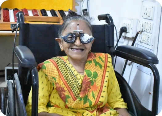 An old lady is sitting in wheelchair for eye checkup